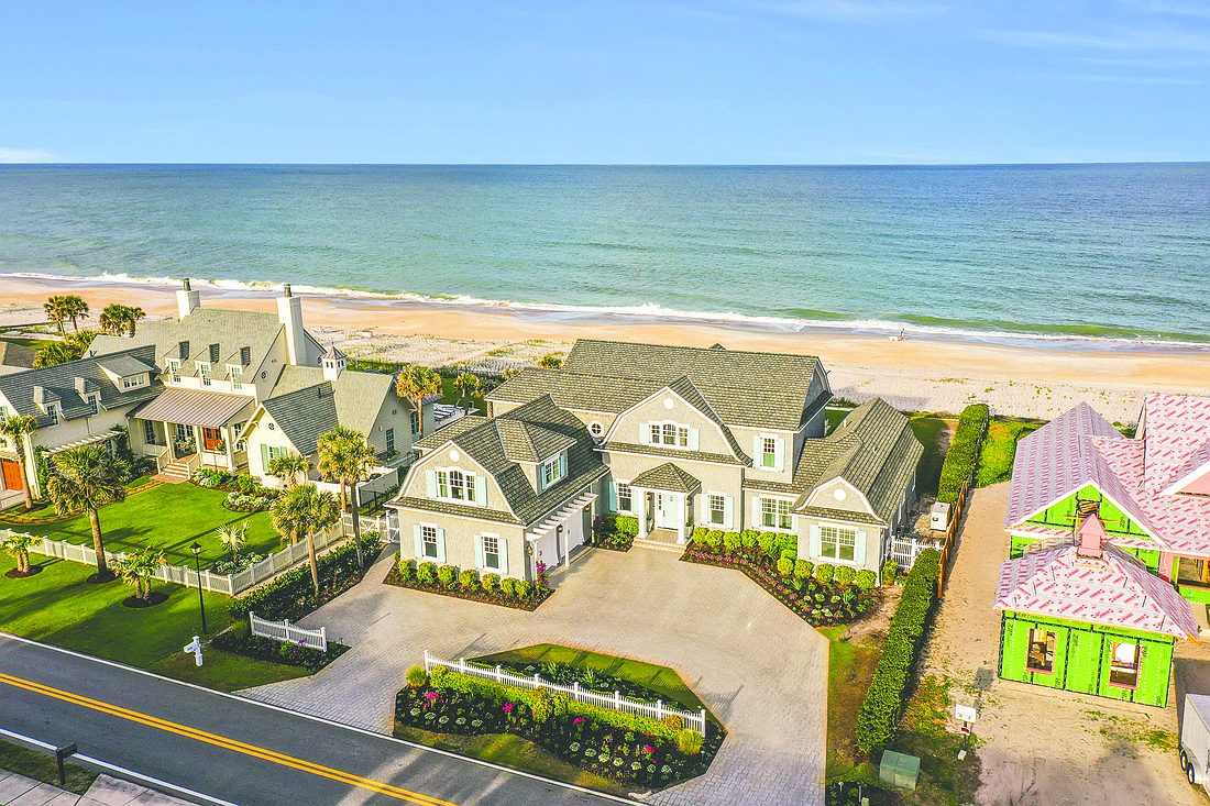 Oceanfront two-story home with pond and golf views features six bedrooms, five full and one half-bathrooms, patio, porches, pool, dune walkover and two-car garage.