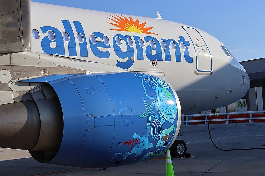 A sea life-themed wrap covers the engine of an Allegiant plane based at Sarasota-Bradenton International Airport.