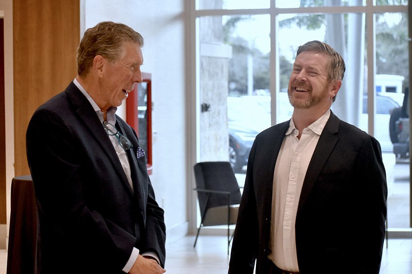 Tom Gardner and Rob Toomey talk in the reception area.