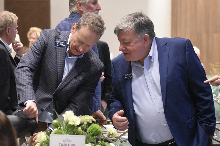 Len Carney and Kevin Casey pour tea during the brunch.