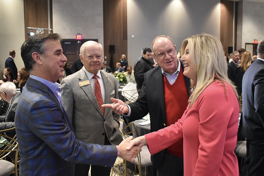 Jeff Limbocker, Charlie Murphy, Jim Tollerton and Heather Kasten greet one another.