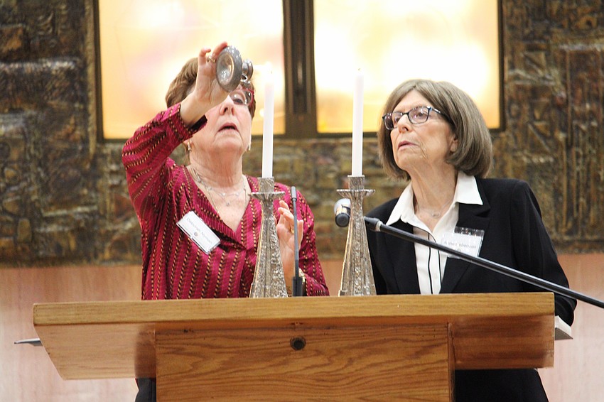 Anne Lieberman and Deborah Nyman light the candles for Friday's Shabbat service at Temple Beth Israel.