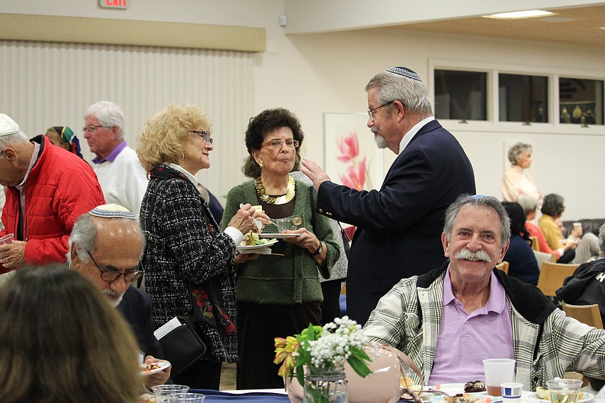 Attendees enjoy a celebratory dinner after Friday's Shabbat service at Temple Beth Israel.