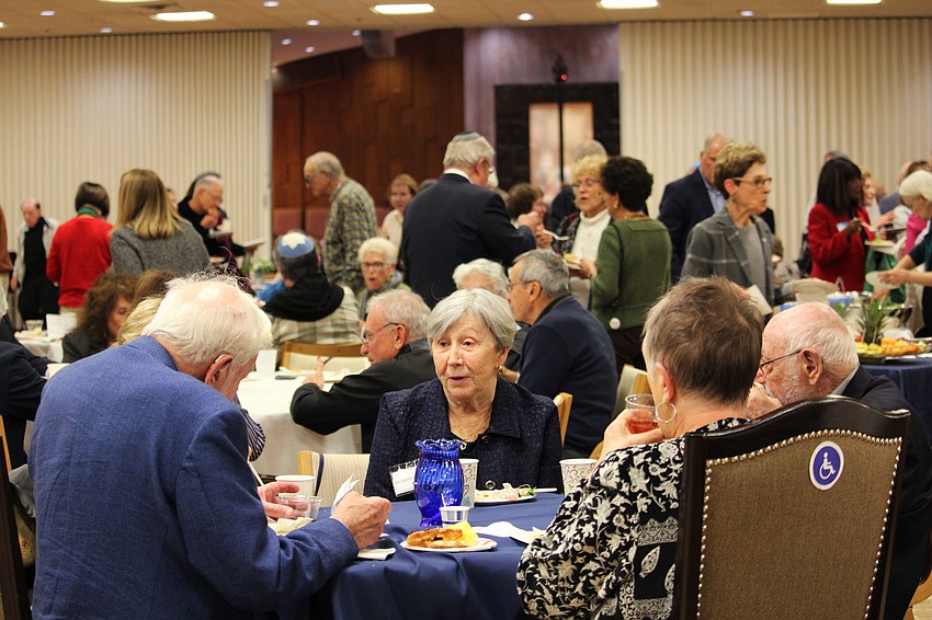 Attendees enjoy a celebratory dinner after Friday's Shabbat service at Temple Beth Israel.