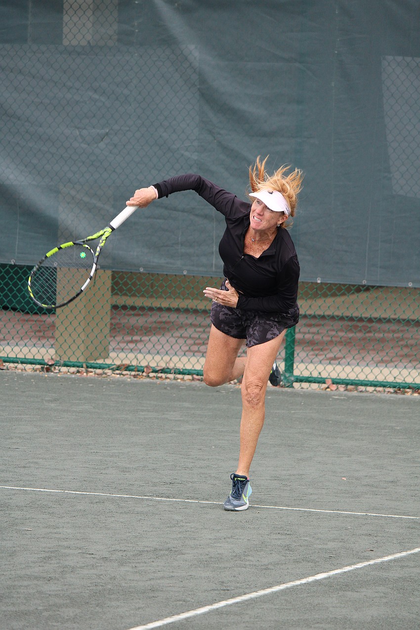 Michelle Coates serves up the ball.