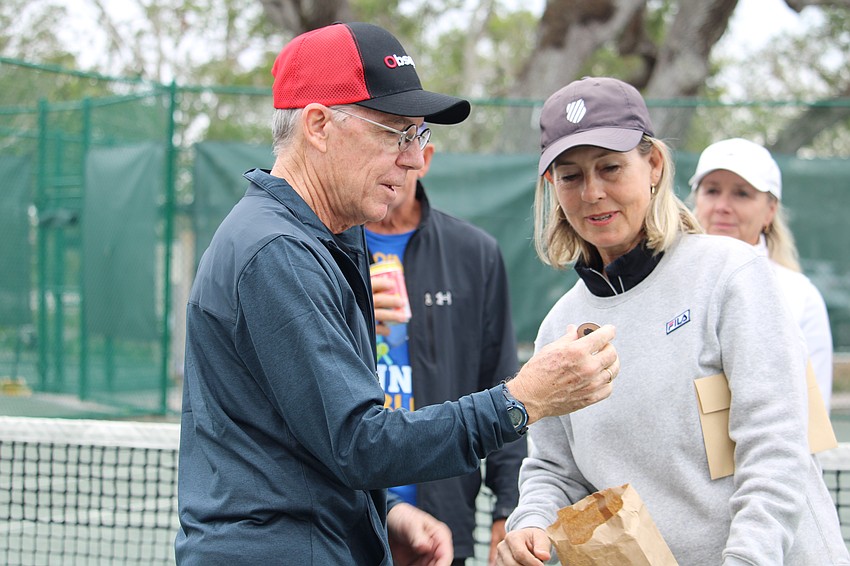 Matt Walsh and Kay Thayer select the winner of the grand prize drawing.