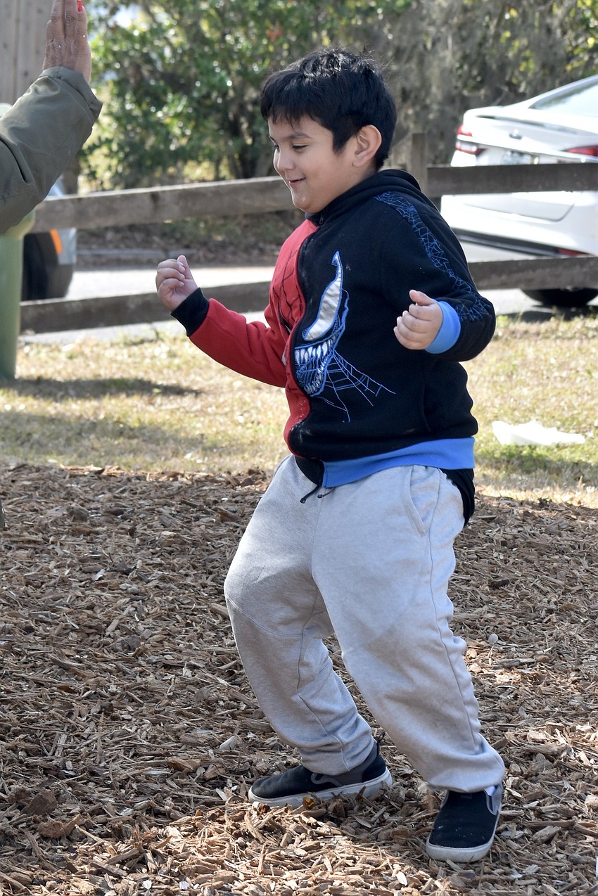 Arian Tobon, 7, dances with his great grandmother Yolanda Bass.