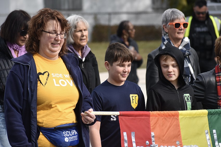 Lisa Ellis, Judah Testone, 11 and Ellis' son AJ Ellis, 10, march with Unitarian Universalists of Sarasota.