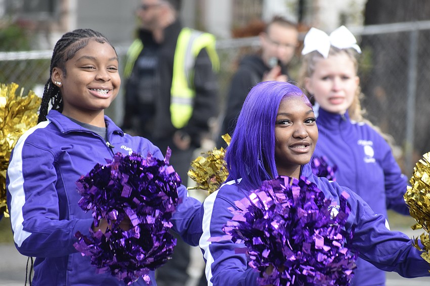 Ninth graders Eloni Cheaves and Byreelle Castleberry, and tenth grader Chloe Lopez, walk with the Booker High School cheerleading squad.