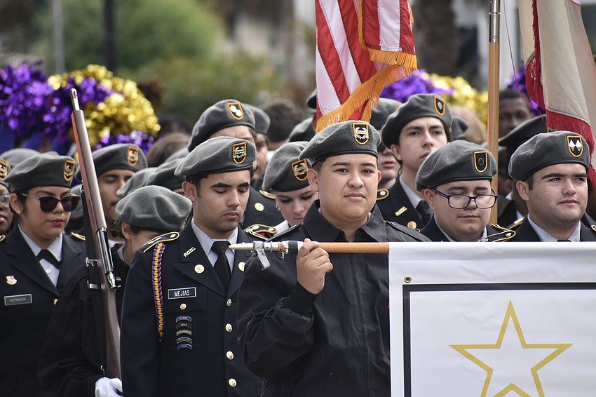 The Booker High School JROTC squad marches along.
