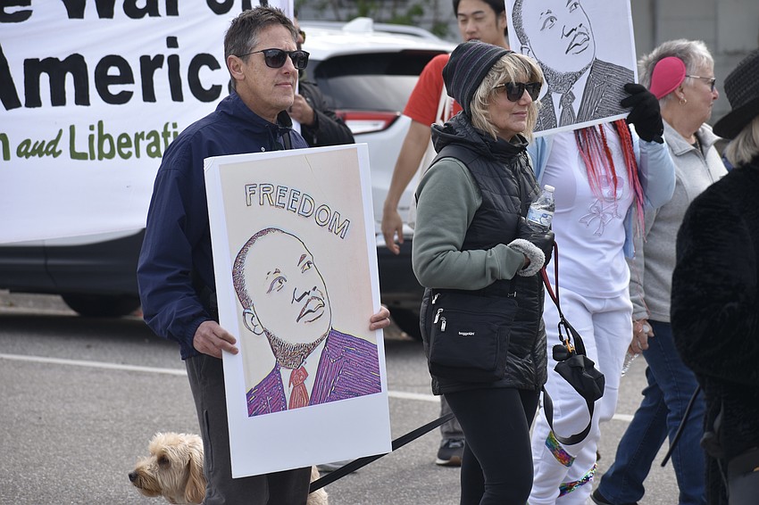 Keith and Chris Spirgel walk with their dog Bodhi.