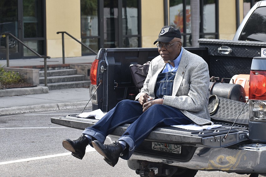 Former Sarasota mayor Willie Shaw rides a pickup truck at the front of the walk. 

