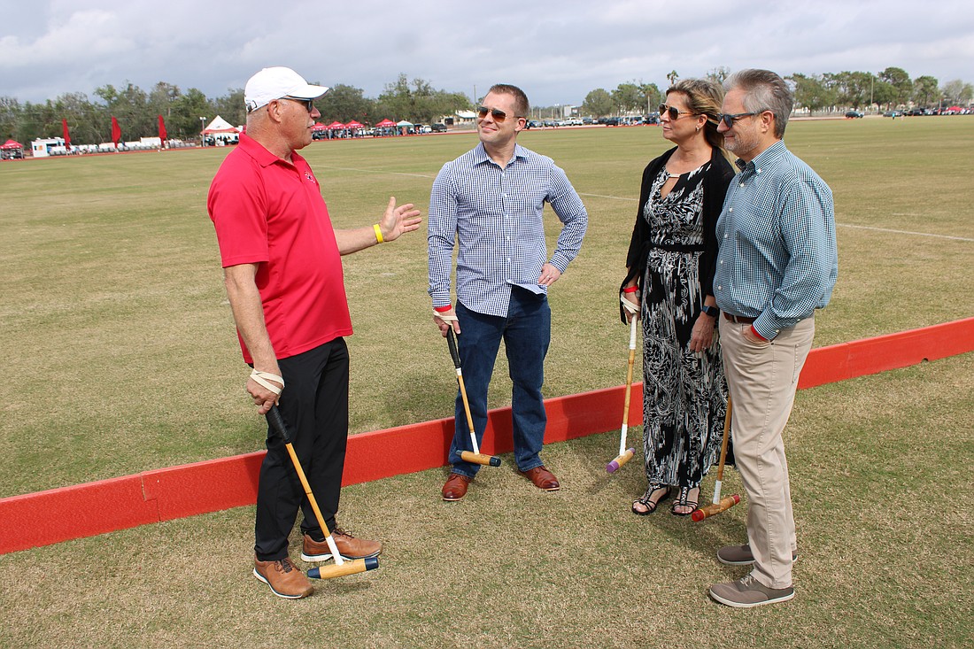 Former polo pro Bob Brosious gives some quick instruction to Raymond Dweck, and Lisa and Mark Friedman during Polo with the Pros at the Sarasota Polo Club Jan. 19.