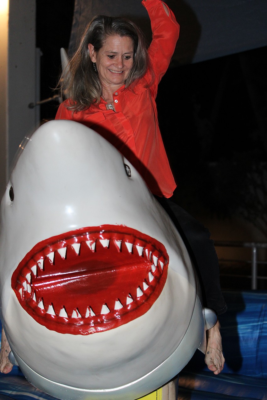 Julie Mastropierro gives the mechanical shark a spin.