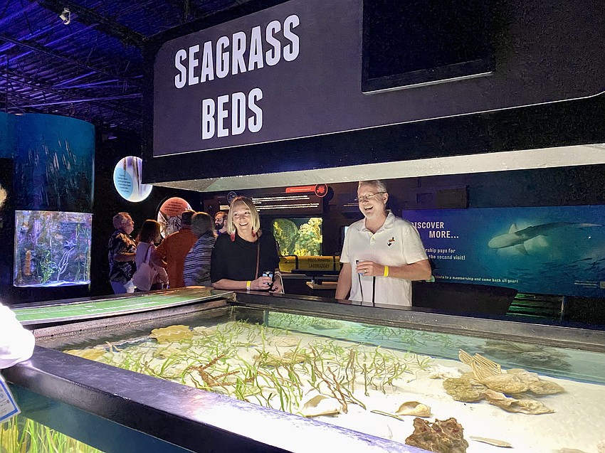 Kathleen and Wade Brennan share a laugh at the seagrass beds exhibit with one of the Mote experts.