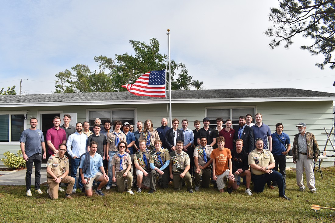 Eagle Scouts past and present gather together in front of the Don Collins Scout House.