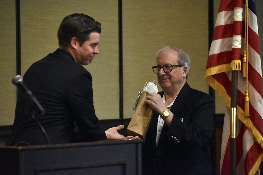 Austin Dickinson offers a gift to Robert Wolfe.