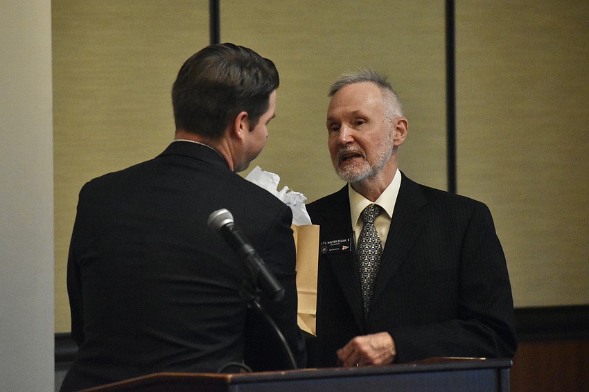 Austin Dickinson offers a gift to Walter Rodak.