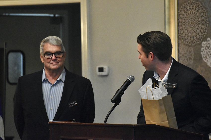 Dan Sullivan receives a gift from Austin Dickinson.