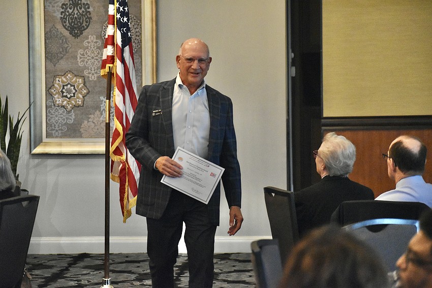 Michael Landis returns to his seat with an Excellence in Teaching award.