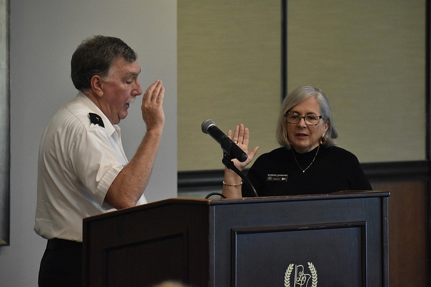 Ron Jones swears in Commander Barbara Warshaw.