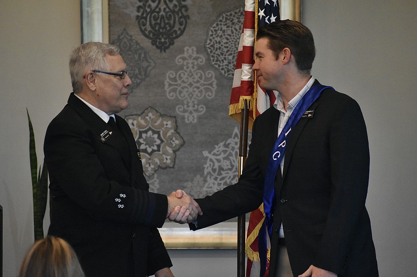 Barry Rush thanks outgoing commander Austin Dickinson for his service to the organization.