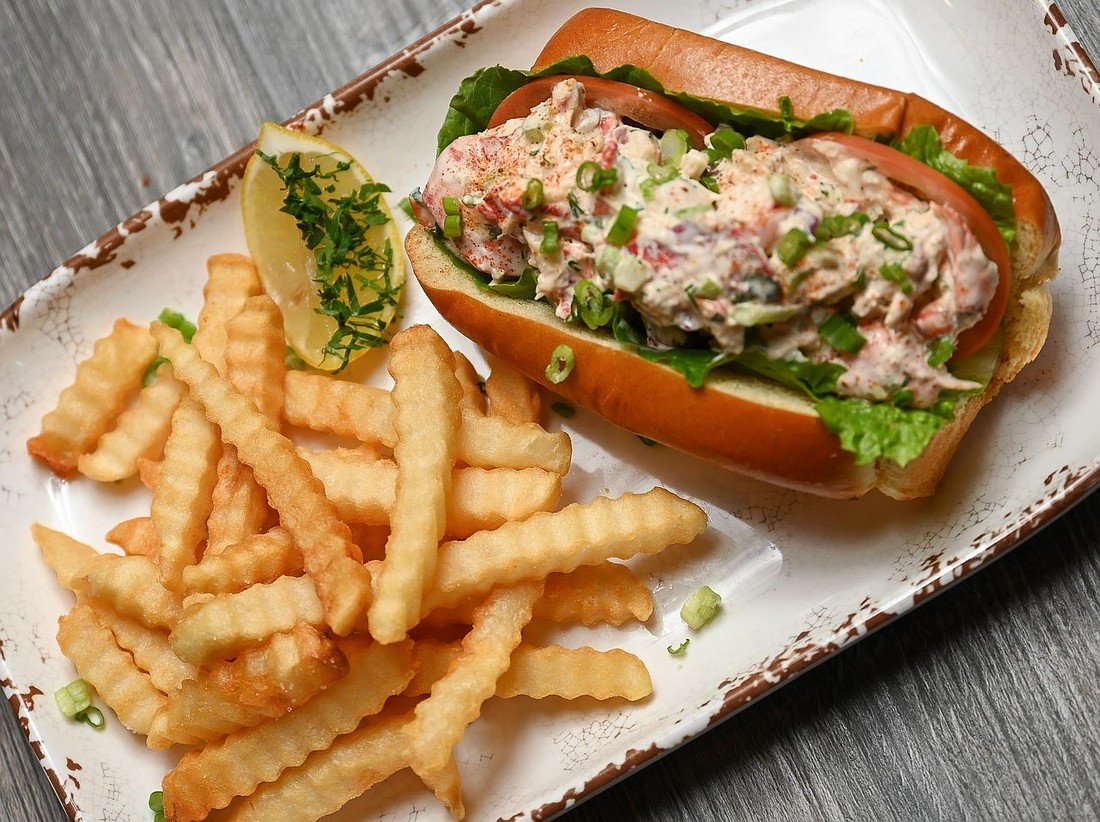 The handheld section of the Lefty's menu features a Maine lobster roll, grouper sandwich, seafood tacos, smash burger, fried chicken thigh sandwich and soft shell crab BLT.