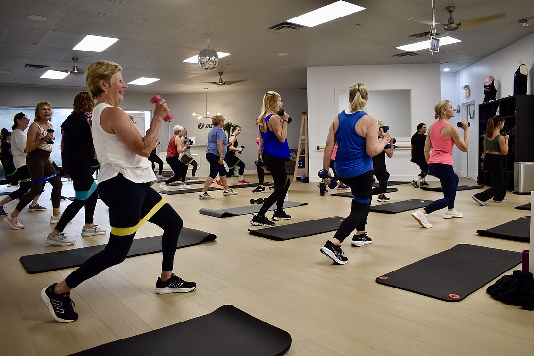 Students work their muscles with weights and with laughing at Jazzercise.