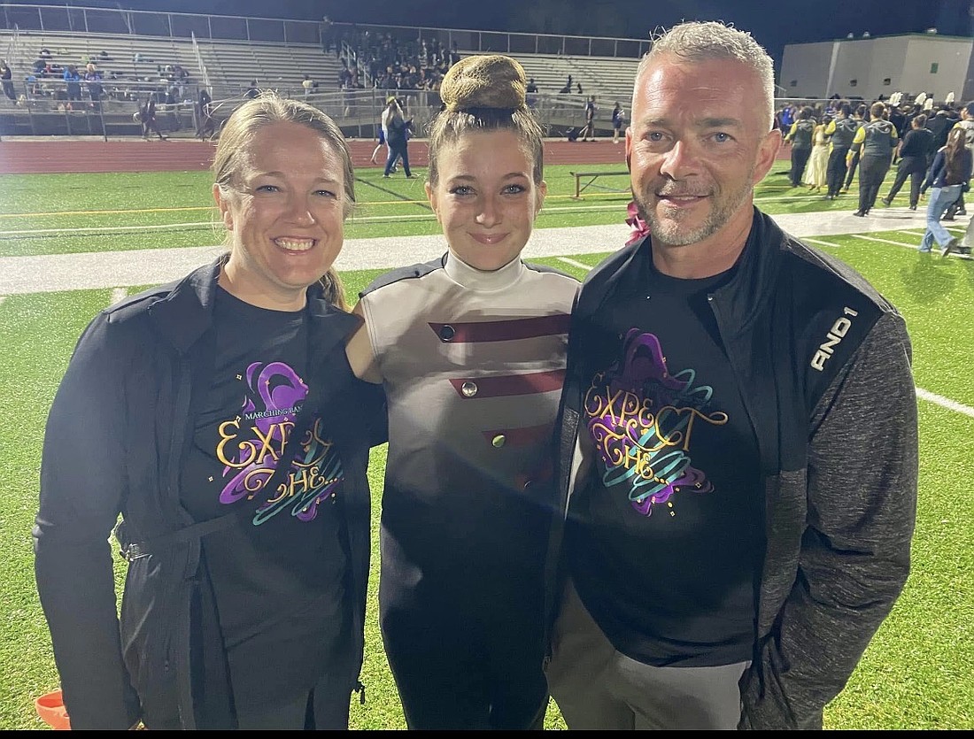 Sara and Danny Abercrombie show support for their daughter Allyson by wearing marching band T-shirts and volunteering for the Boosters.