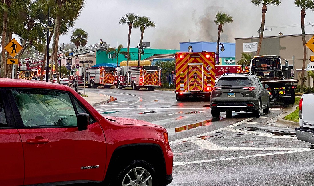 Fire crews from Sarasota County and Longboat Key work to put out a fire at Rochelle's Boutique on St. Armands Circle Jan. 23.