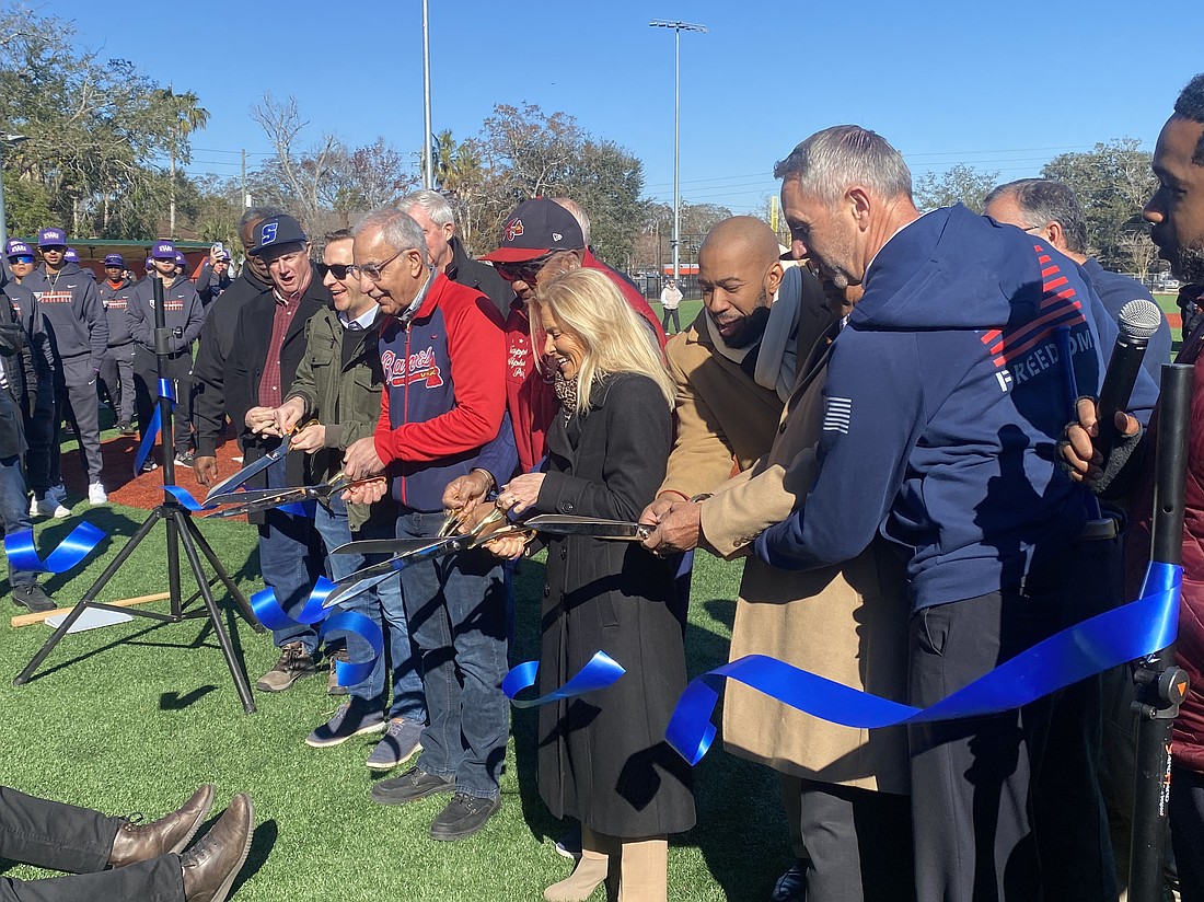 Council member Ron Salem, wearing an Atlanta Braves jacket, and Mayor Donna Deegan, along with other officials, cut the ribbon Jan. 24 on the renovated J.P. Small Park at 1701 Myrtle Ave. N. in Durkeeville.