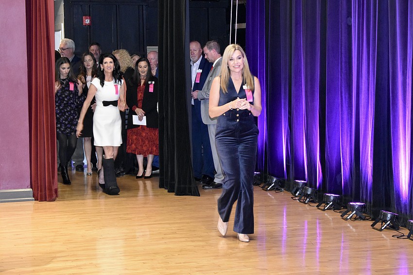 Elena Cassella of Foundation for Dreams prepares to accept the check.