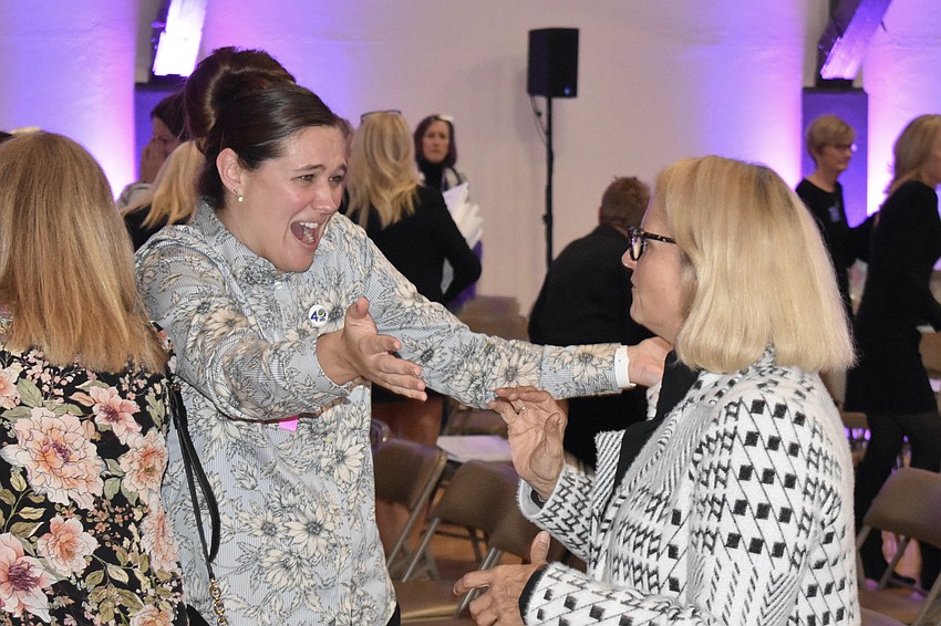 Beth Walters offers a hug to Sandy Shuster as the awards are given out.