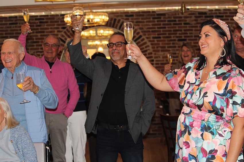 Eleni Sokos, Café on St. Armands' executive vice president and managing partner, offers a cheers.