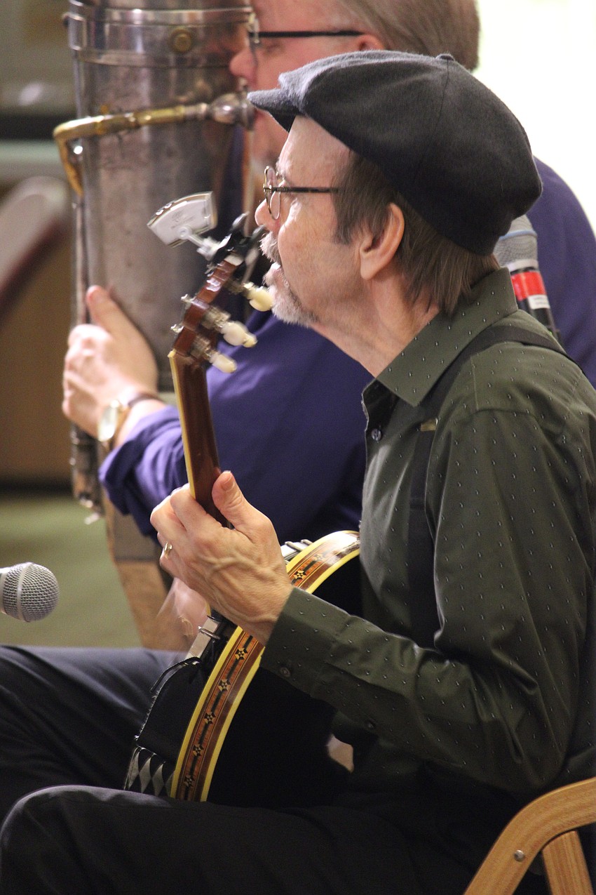 Paul Scavarda plucks the banjo.