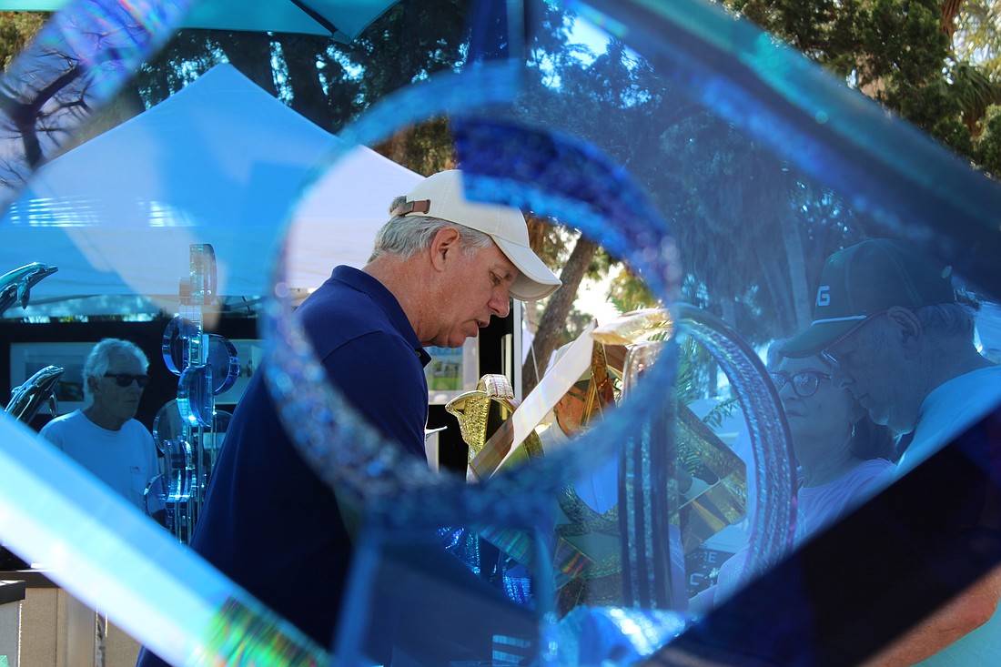 Artist Michael George chats with visitors at the St. Armands Circle Art Festival.