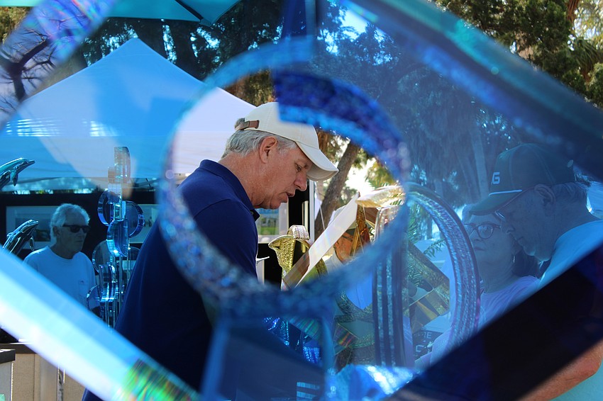 Artist Michael George chats with visitors at the St. Armands Circle Art Festival.