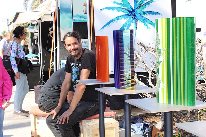 Naples-based artist Wesley Rasko chats with visitors about his art.