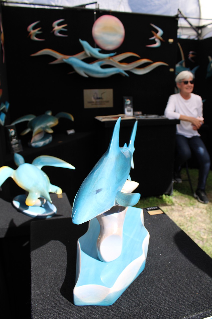 Kim Holzbaur sits among the work of her husband, Werner.