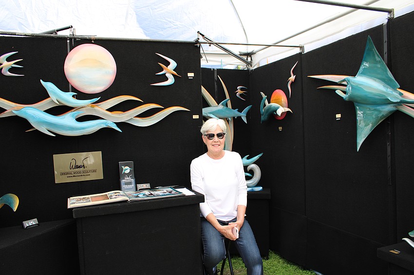 Kim Holzbaur sits among the work of her husband, Werner.