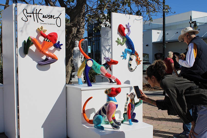 Visitors admire the work of Scott Causey.