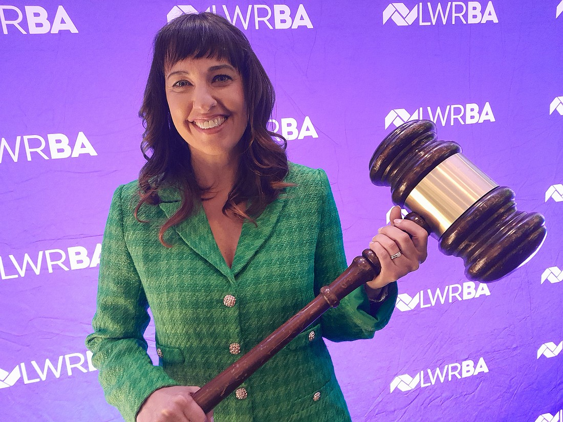 Julie Fanning holds the ceremonial gavel in taking over as the 2025 chair of the board for the Lakewood Ranch Business Alliance.