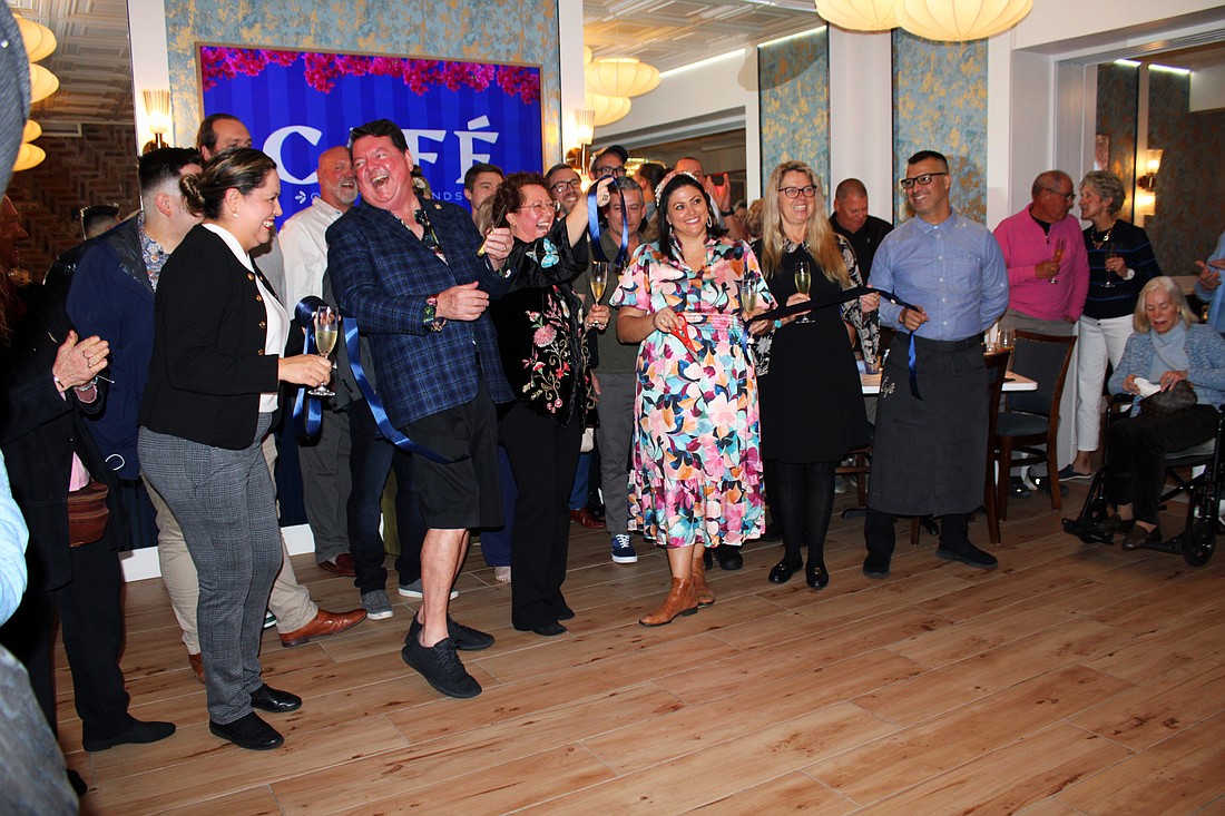 Celebrants cut the ribbon for the official opening of Café on St. Armands.