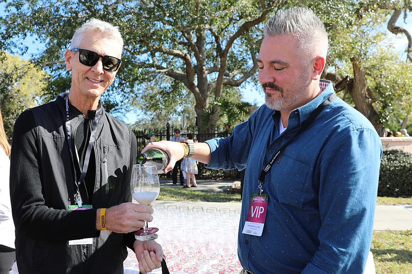 Board member Marc Grimaud pours some bubbly for VIP guest Bob Knudtson as he enters Forks & Corks at Ringling Museum.
