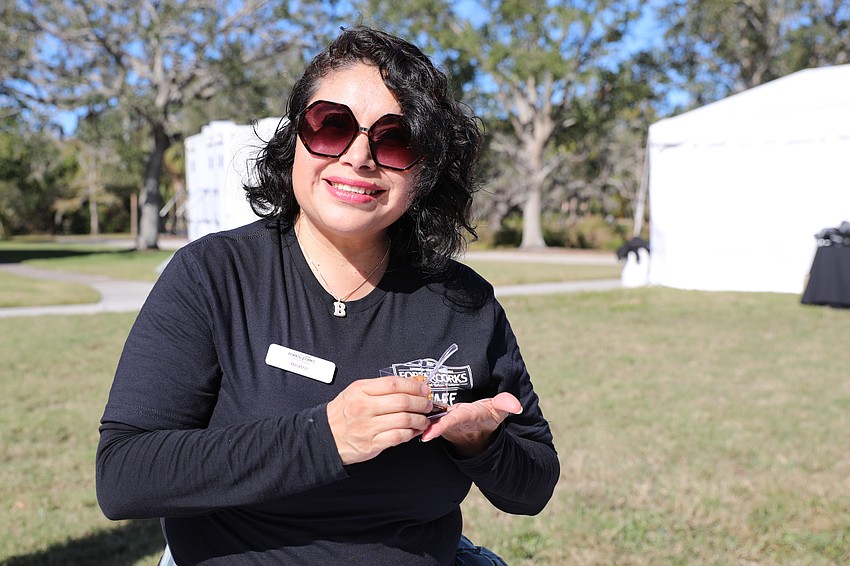 Beatriz Alvarez passes out churros in chocolate sauce at Forks & Corks.