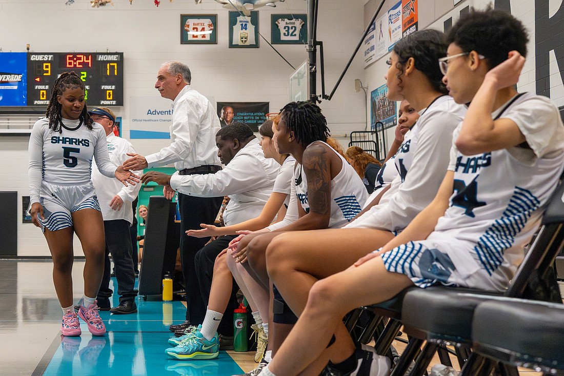 Volusia County Sheriff Mike Chitwood gives Atlantic player Essence Johnson a congratulatory hand slap as she comes out of the game. Courtesy photo