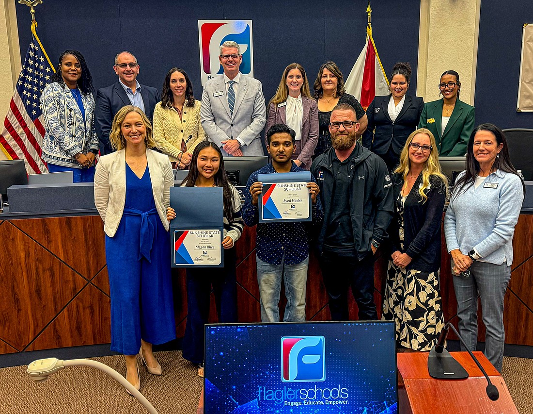 Sunshine State STEM Scholar Syed Haider and alternate Megan Rhee with their principals, Kristin Bozeman and Bobby Bossardet, district teaching and learning specialists Sarah Lombardo and Heidi Alves and (back row) Superintendent LaShakia Moore, School Board members Will Furry, Christy Chong, Derek Barrs, Lauren Ramirez and Janie Ruddy and Student board members Jeh-Hanni Strong and Dani Nieves. Photo courtesy of Flagler Schools.