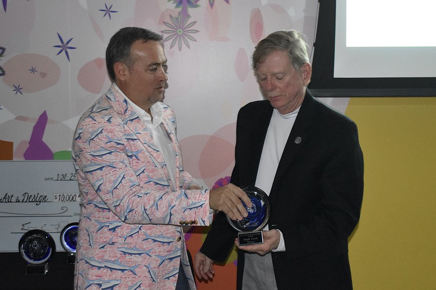 Board chair Eric Fleming presents an award to Commissioner Mark Smith, who was presented with the Service and Leadership award and has served on  boards and committees including the sheriff's advisory board, All Faiths Food Bank, the Siesta Key Village Association, the Siesta Key Association and the Siesta Key Chamber of Commerce.
