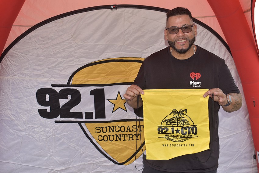 Promoter Tony Rosario hands out swag for 92.1 CTQ, a local radio station.