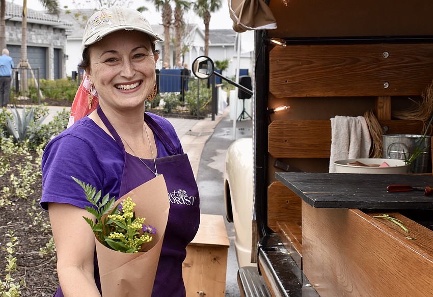 Guests pick three flower stems, and Stevie Krumm, owner of Sarasota Florist, wraps them to go.